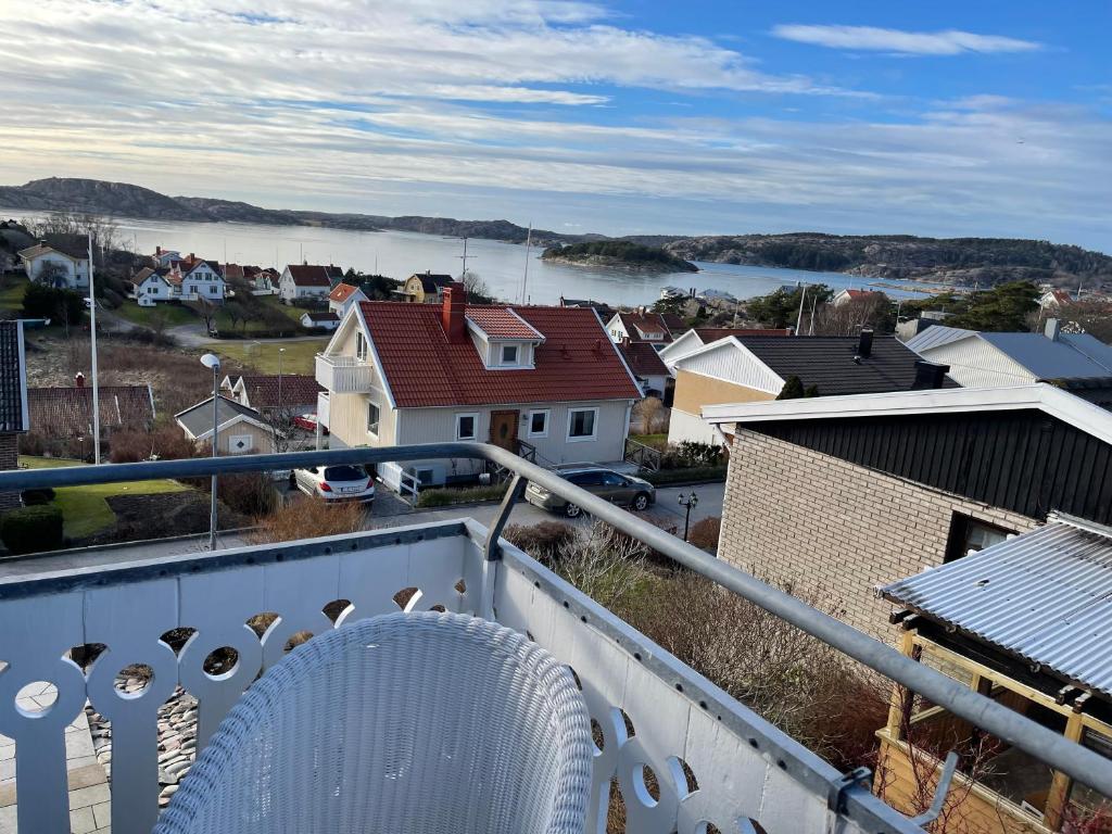 弗加尔巴卡Tallgatan Fjällbacka的坐在房子阳台上的白色椅子