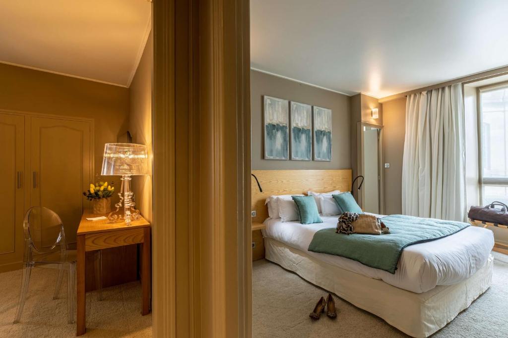 欧里亚克波尔多贝斯特韦斯特大酒店的一间卧室配有一张床、一张书桌和一个窗户。
