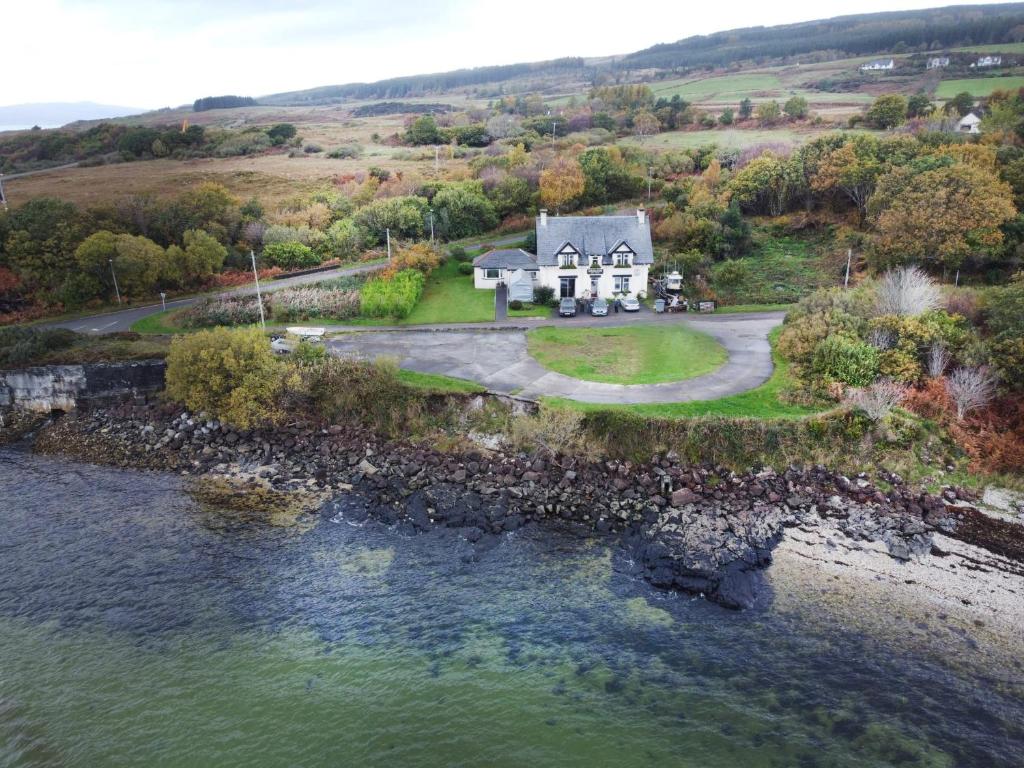 LochalineLochaline Hotel的水体旁房子的空中景观