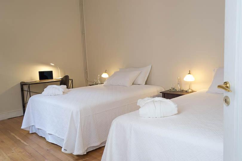 圣地亚哥Hotel Boutique Casa Conde的客房内的两张床和白色床单