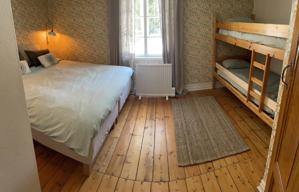 马隆HomeSweetSweden的一间卧室设有两张双层床,铺有木地板。
