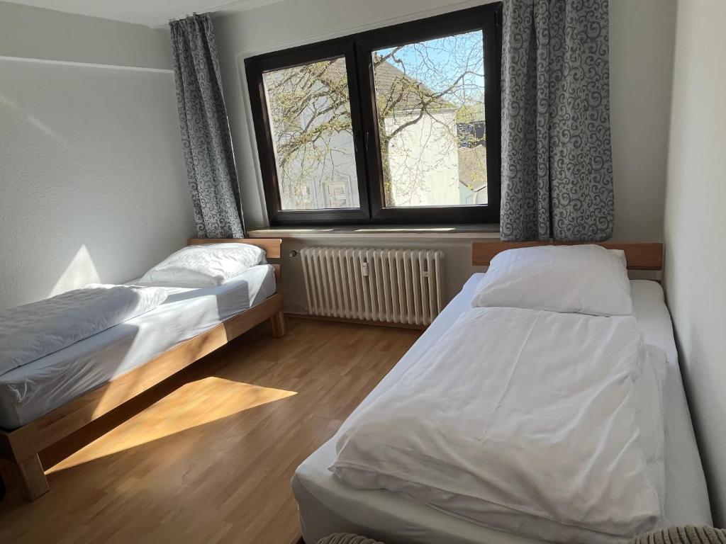 埃森Zimmer für Monteure, Handwerker oder Reisende的一间卧室设有两张床和窗户。