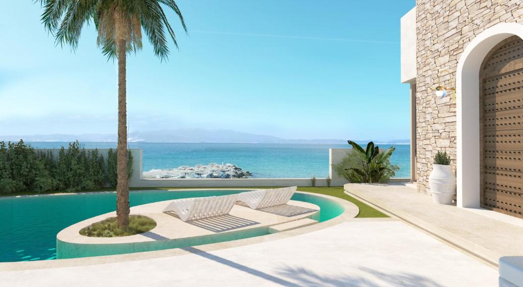 斯卡拉索提罗斯Byblos Aqua-The Sea Front Luxury Villa的一座别墅,设有游泳池和棕榈树