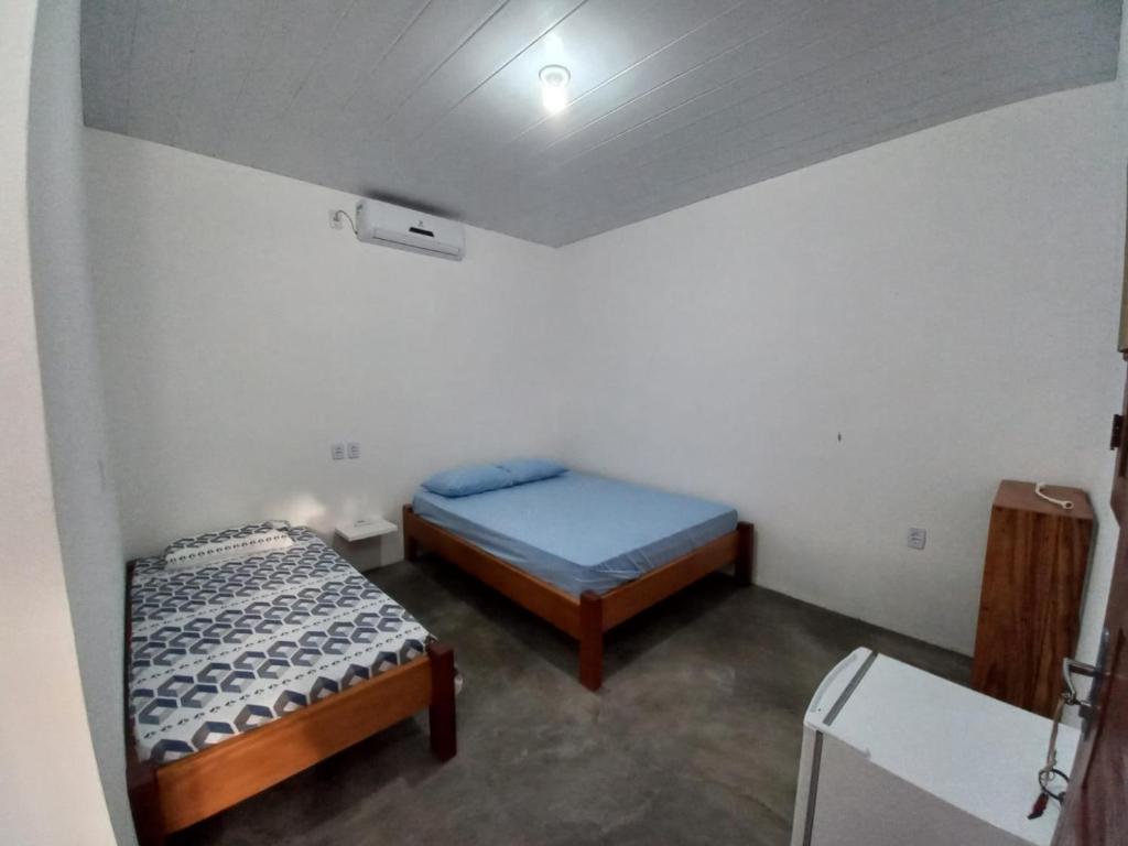 阿廷斯POUSADA DO BETO的一间设有两张床铺的客房,位于一个天花板上