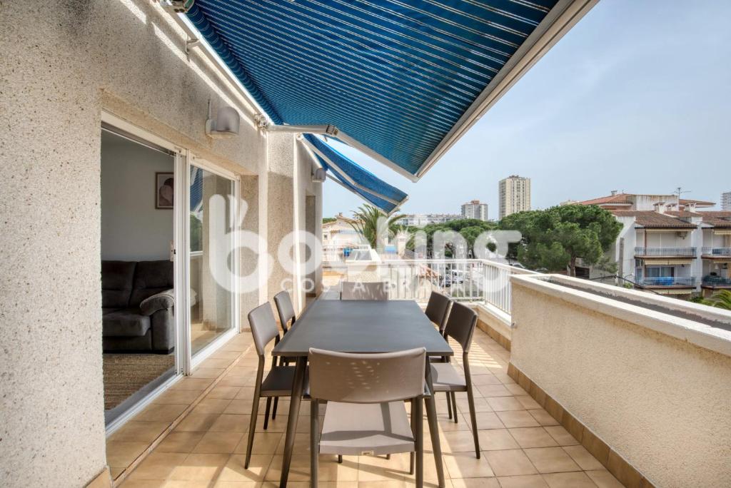 普拉加德阿罗Blanco Apartament per 6 persones a 5 minuts de la Platja Gran的阳台配有黑色的桌子和椅子。