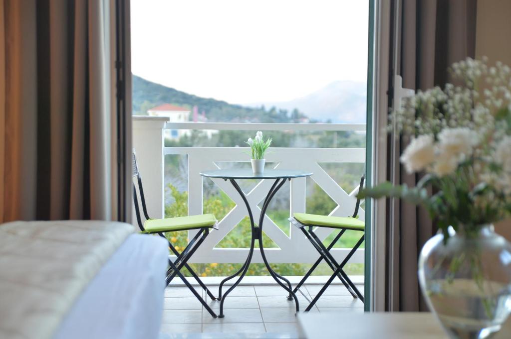 里科索翁瑞瓦纳扎别墅公寓的阳台配有桌子和两把椅子,设有窗户。