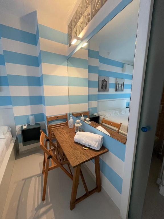 卡莫利葛丽泰之家旅馆的小房间设有桌子和床