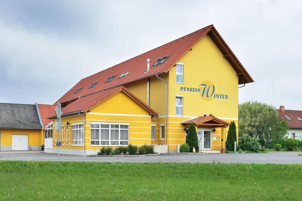 古森多夫福鲁克斯佩威特酒店的黄色的建筑,旁边标有标志