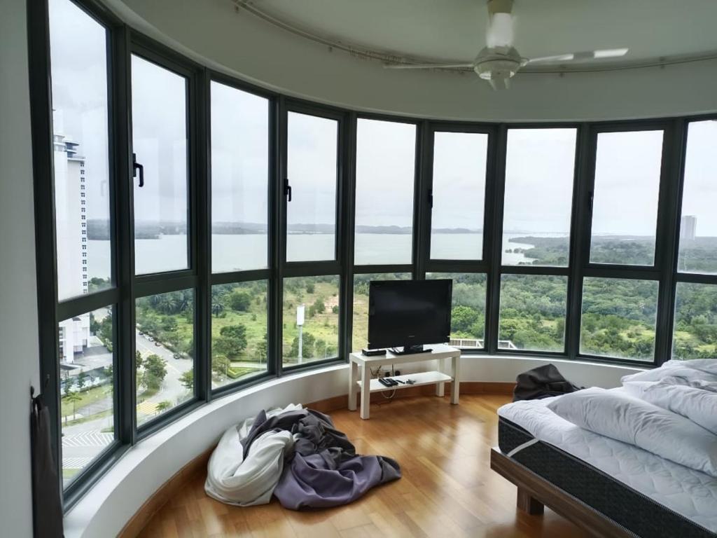 努沙再也Johor Malaysia Teega Suites@ Puteri Harbour Condo 4607 Persiaran Lasamana , Teega Suites的一间卧室设有一张床、一台电视和窗户。