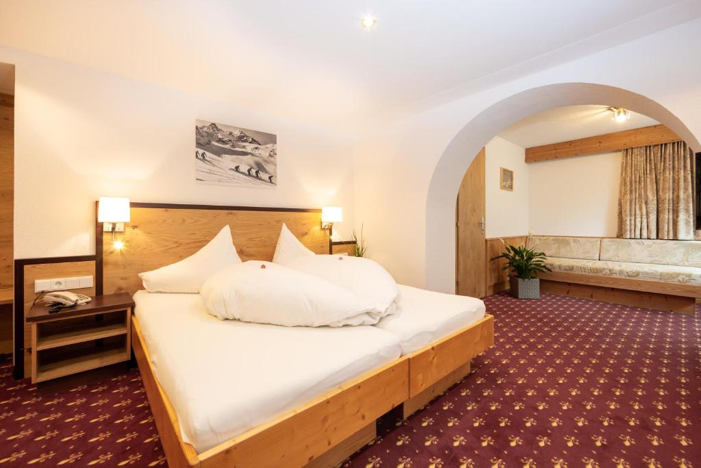伊施格尔Hotel Garni Tyola的一间卧室,卧室内配有一张大床