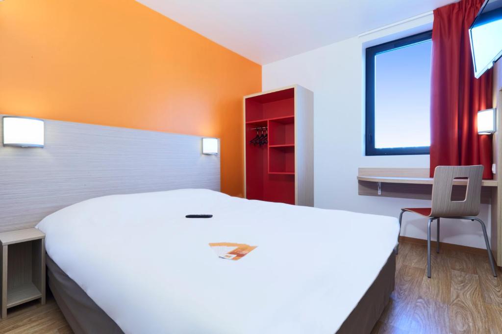 梅里尼亚克波尔多西部 - 梅里尼亚克机场普瑞米尔经典酒店的窗户客房内的一张大白色床