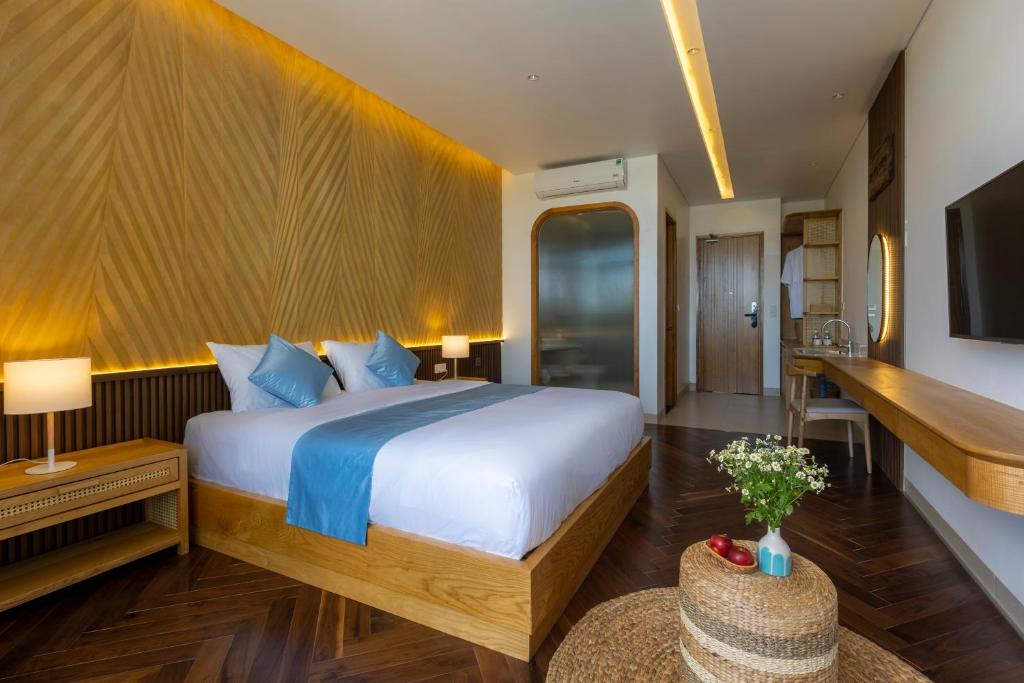 Gò CôngThe Stay Saigon Riverfront的一间卧室配有一张大床和电视