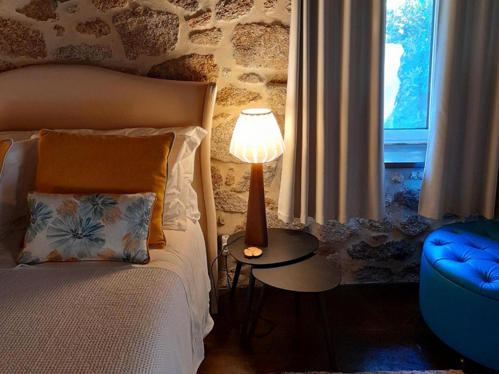 Castelo NovoFragas do Lobo - Casa da Azenha的一间卧室配有一张床和一张桌子上的台灯