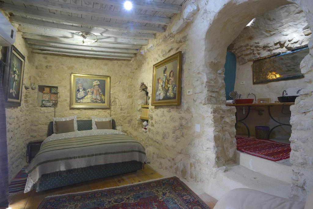 Tāmazrat奥博格德塔梅滋利特酒店的卧室配有一张石墙床