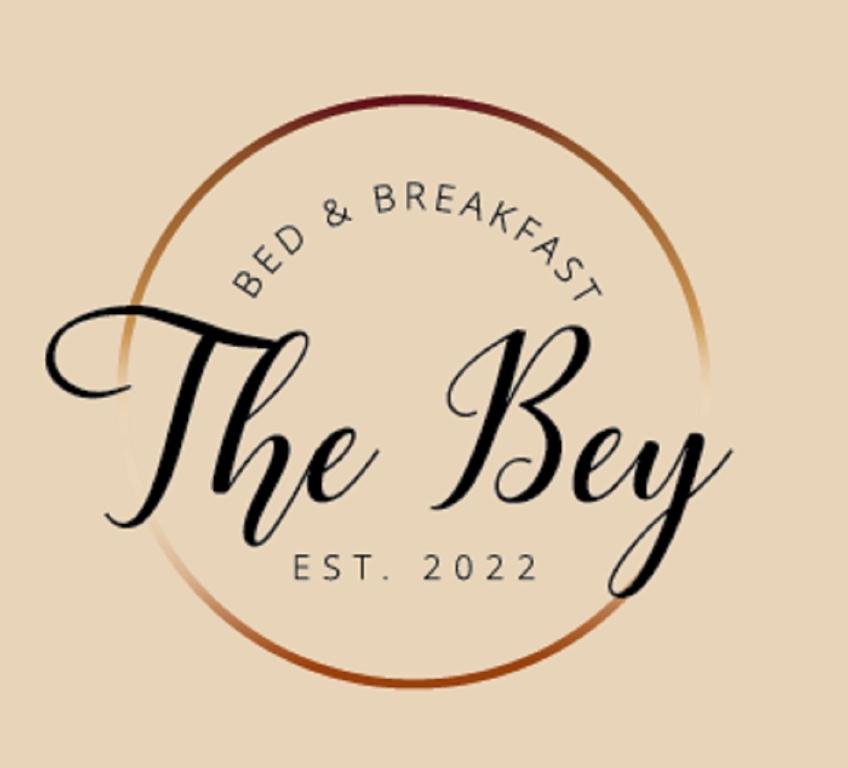 El SocorroThe Bey Bed and Breakfast的东王朝的标志早餐钥匙