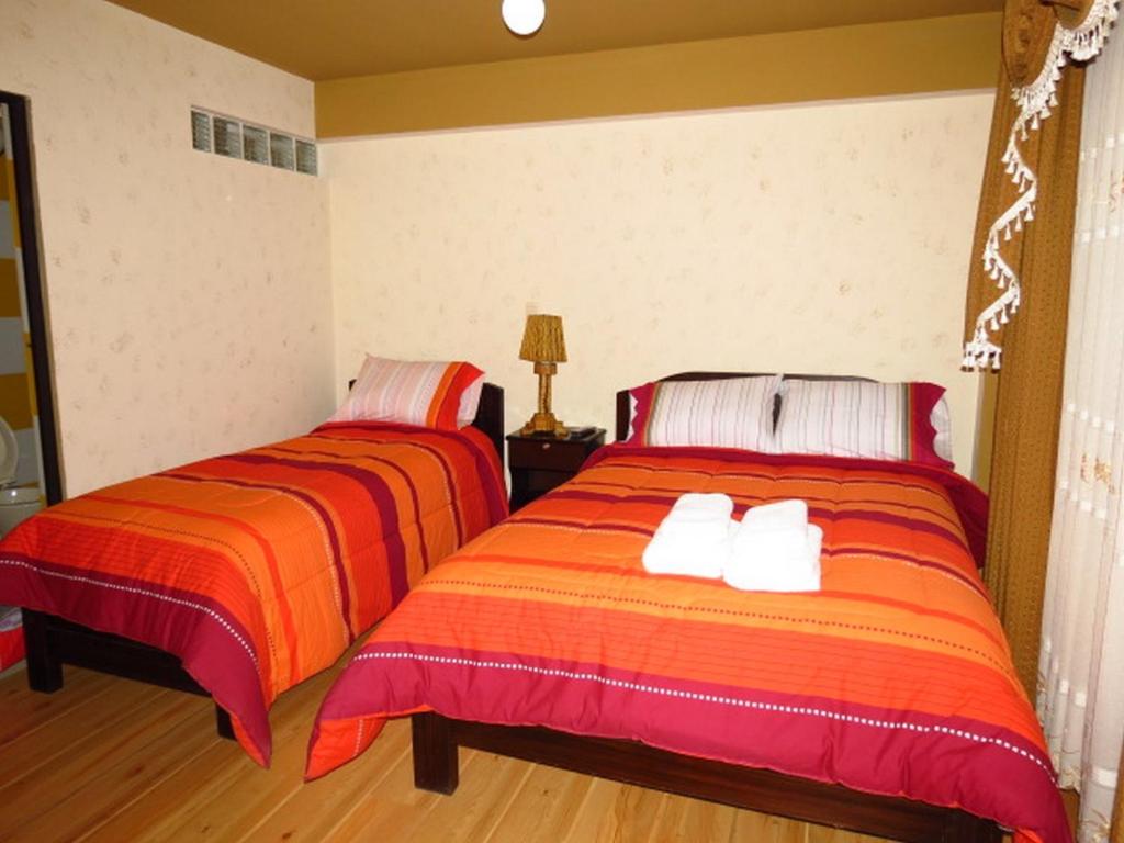乌尤尼朱马利酒店的两张睡床彼此相邻,位于一个房间里