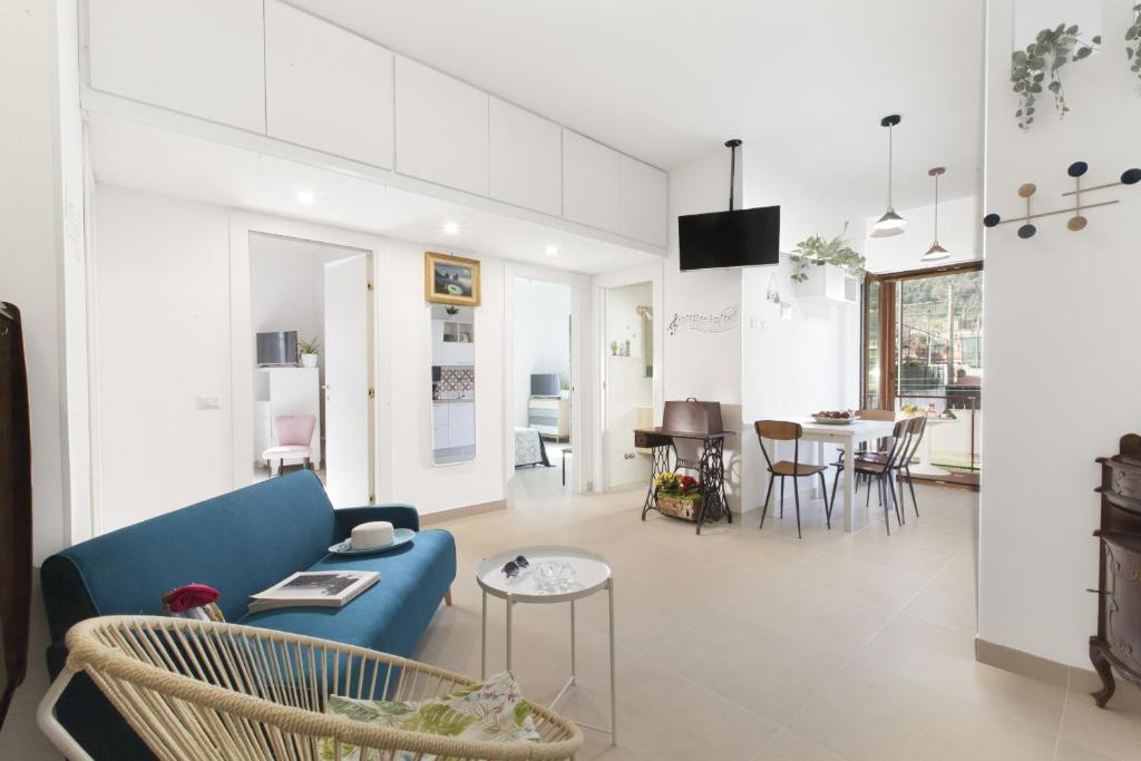 圣安吉洛Estate4home - Casa Luigino的客厅配有蓝色的沙发和桌子