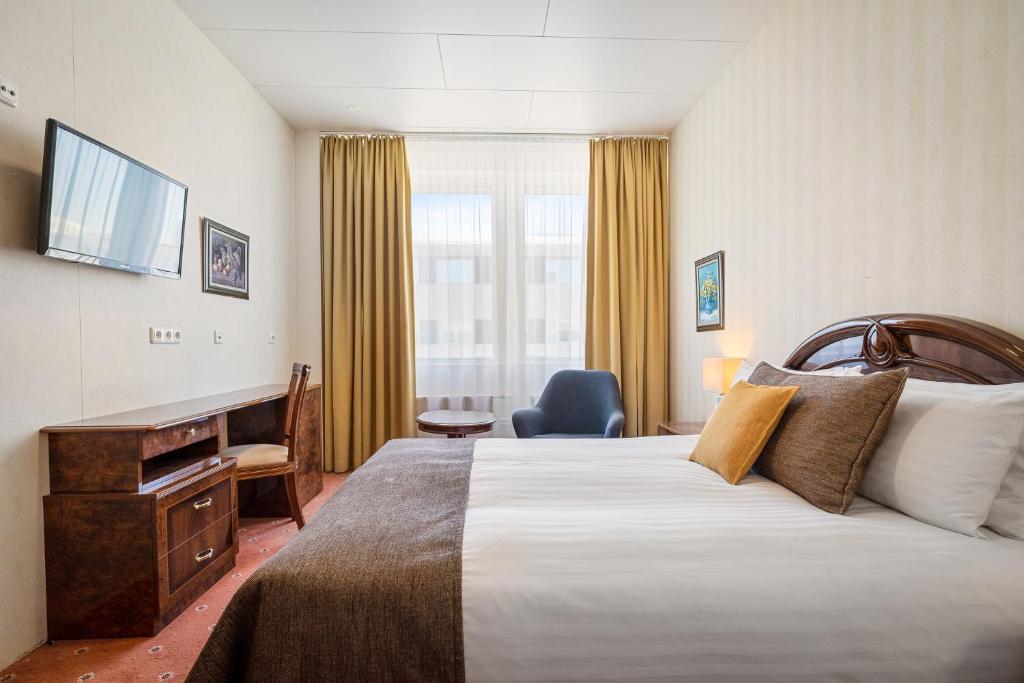雷克雅未克Hotel Ísland - Comfort的酒店客房设有一张大床和一张书桌。
