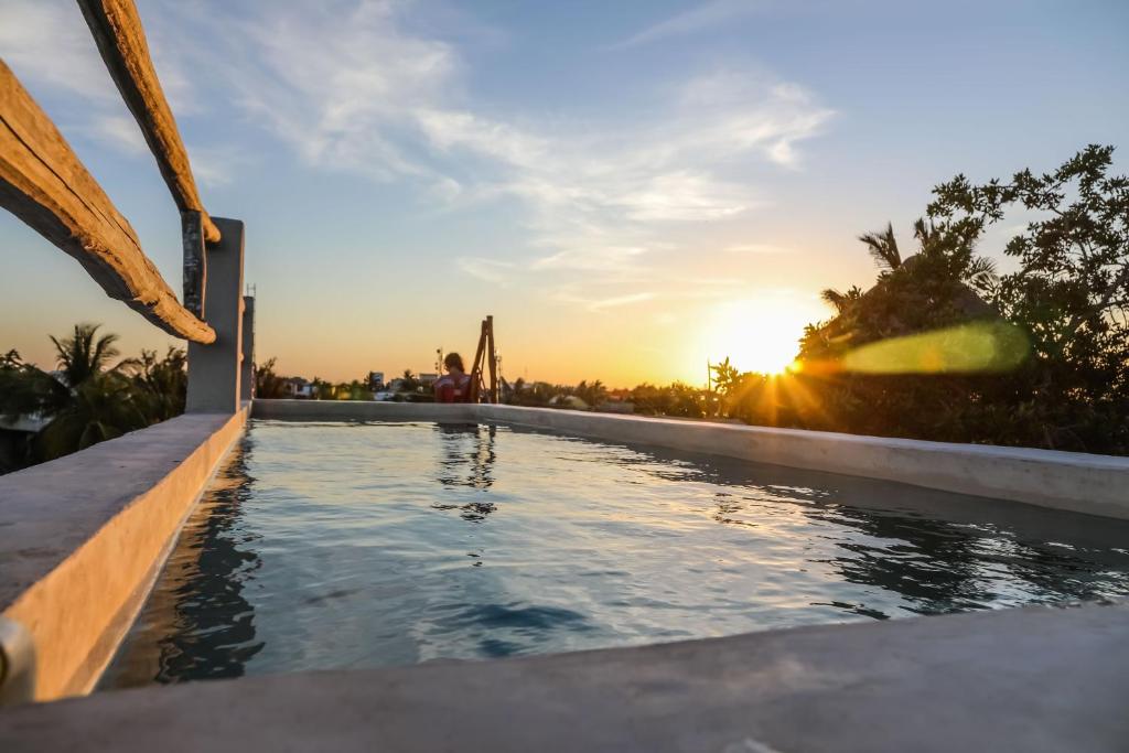 奥尔沃克斯岛La Casa de Mia Holbox的一座享有日落美景的游泳池