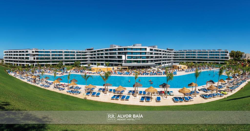 阿尔沃尔RR Alvor Baía Resort的一个带椅子和人的大型游泳池的度假酒店