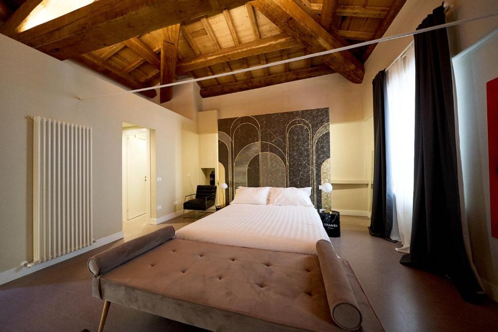 拉奎拉Ginevra Boutique Rooms - Palazzo Leosini - Residenze D'Epoca的一间大卧室,配有一张大床和一张沙发