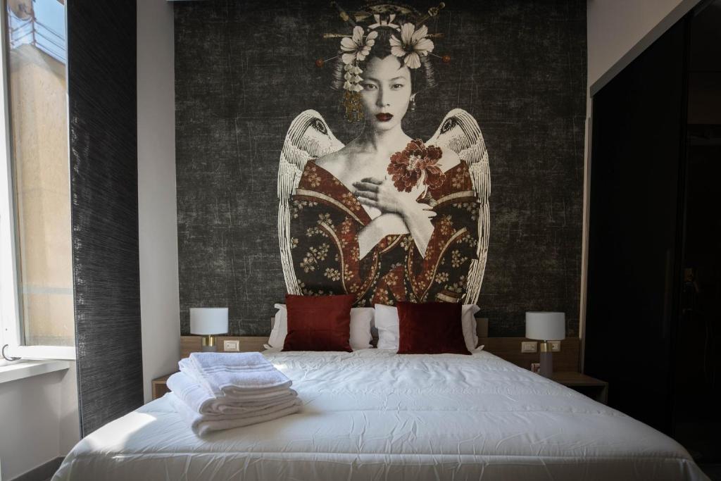 L'élégant BOUTIQUE ROOMS NAPLES客房内的一张或多张床位