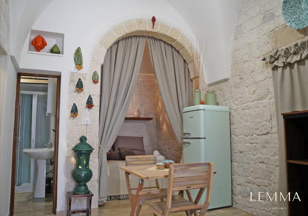 卡洛维诺LEMMA - Casa Vacanze的客房内的厨房配有桌子和冰箱
