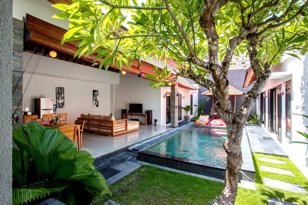 塞米亚克Villa Joylen Seminyak Bali的树别墅内的游泳池