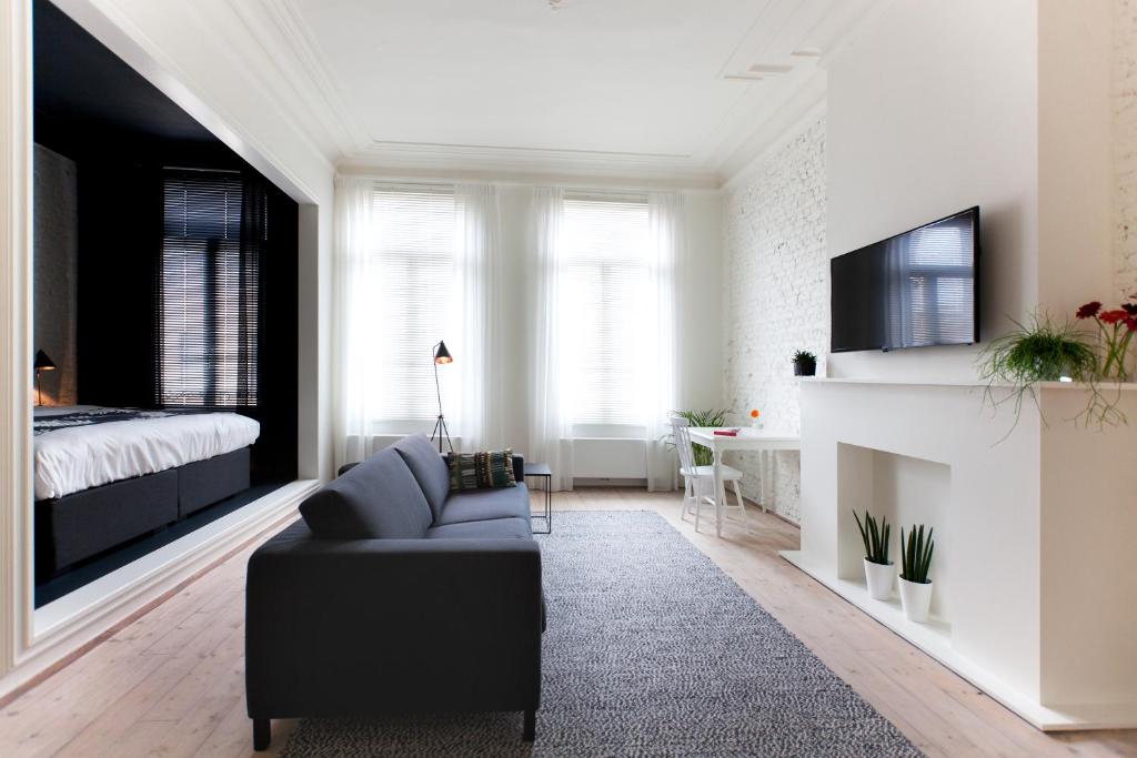 安特卫普国民城市公寓和套房酒店的客厅配有沙发和1张床