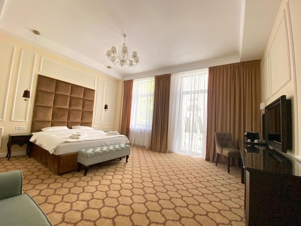 布加勒斯特Venetian Bucharest的一间大卧室,配有一张床和一台电视