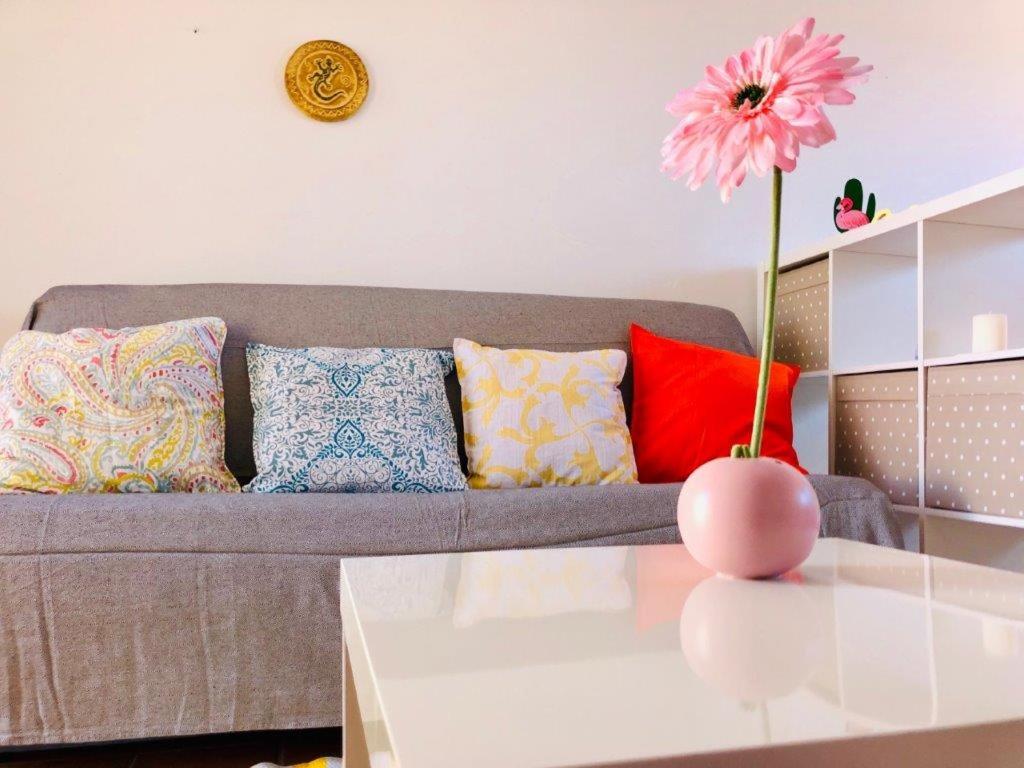 科拉雷侯The Summer Treat Shared Apartment Compartido的客厅配有沙发和带花卉的花瓶