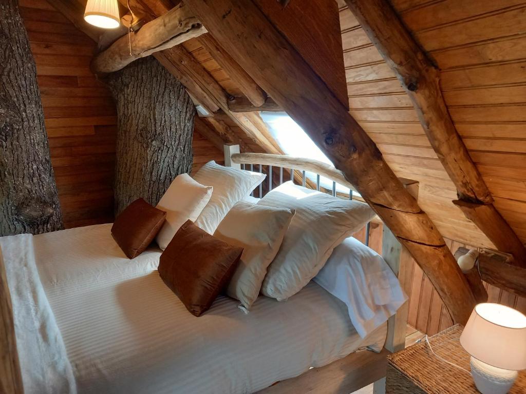伊夫特河畔维勒邦Cabane suspendue dans les arbres的小木屋内一间卧室,配有一张床