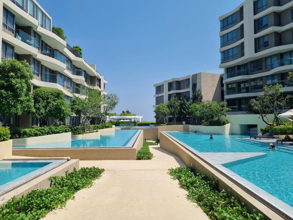 华欣Veranda Residence Hua Hin 1BR Beachfront的建筑中两个游泳池的图片