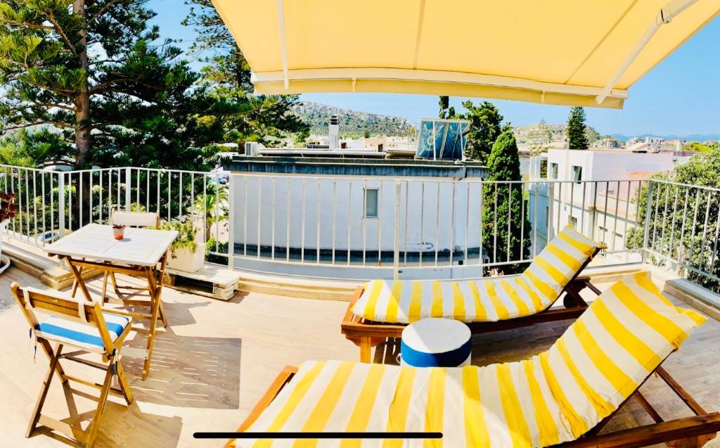 卡利亚里伊尔普罗富莫德尔马酒店的庭院配有桌椅和遮阳伞。