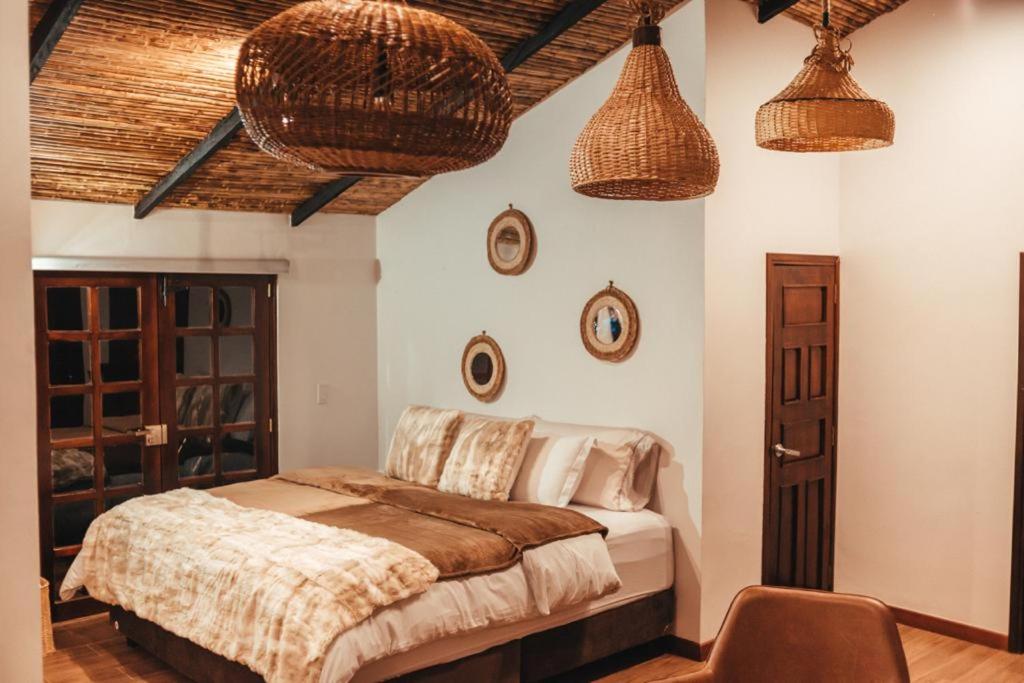 Silvialeremita biohotel的卧室配有一张床,墙上有两个篮子