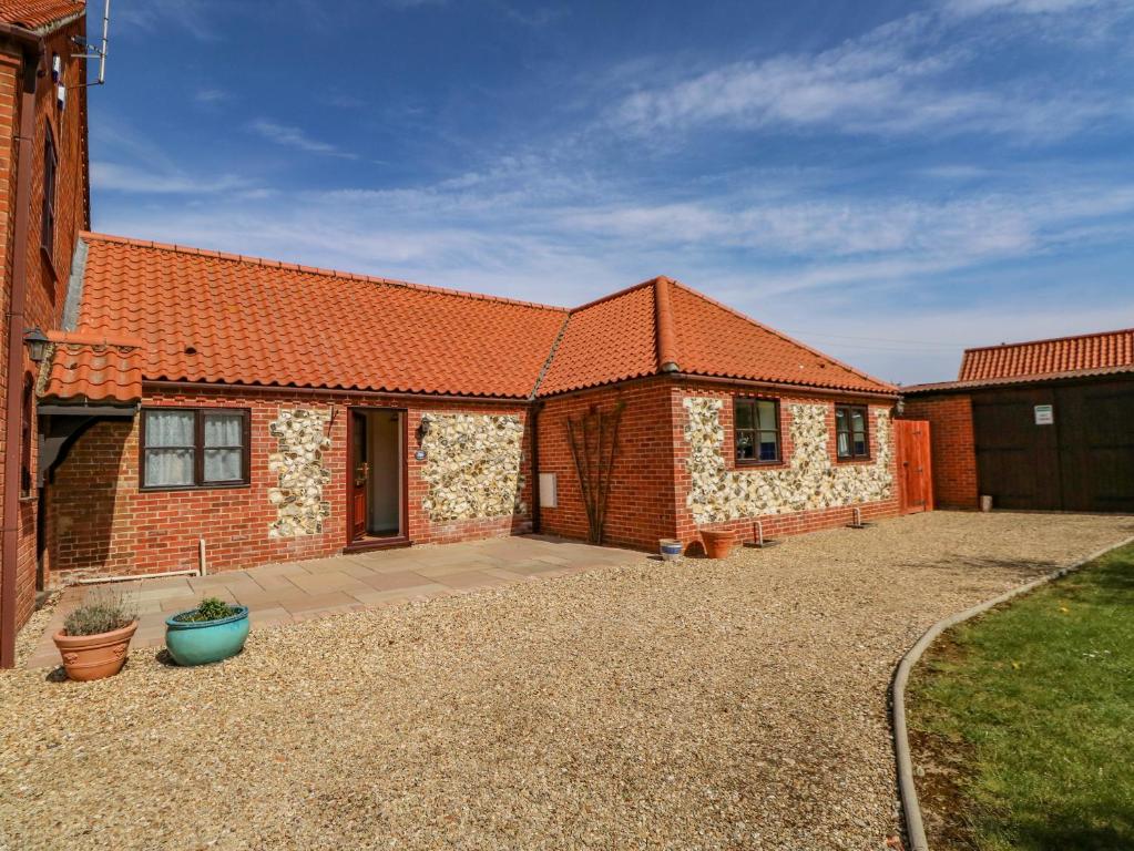 盖顿The Granary Cottage的一座砖房,有橙色屋顶