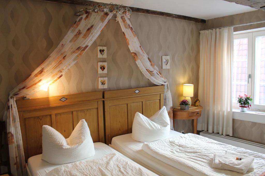 吕贝克菲林豪斯维图切特旅馆的一间卧室设有两张床和天篷