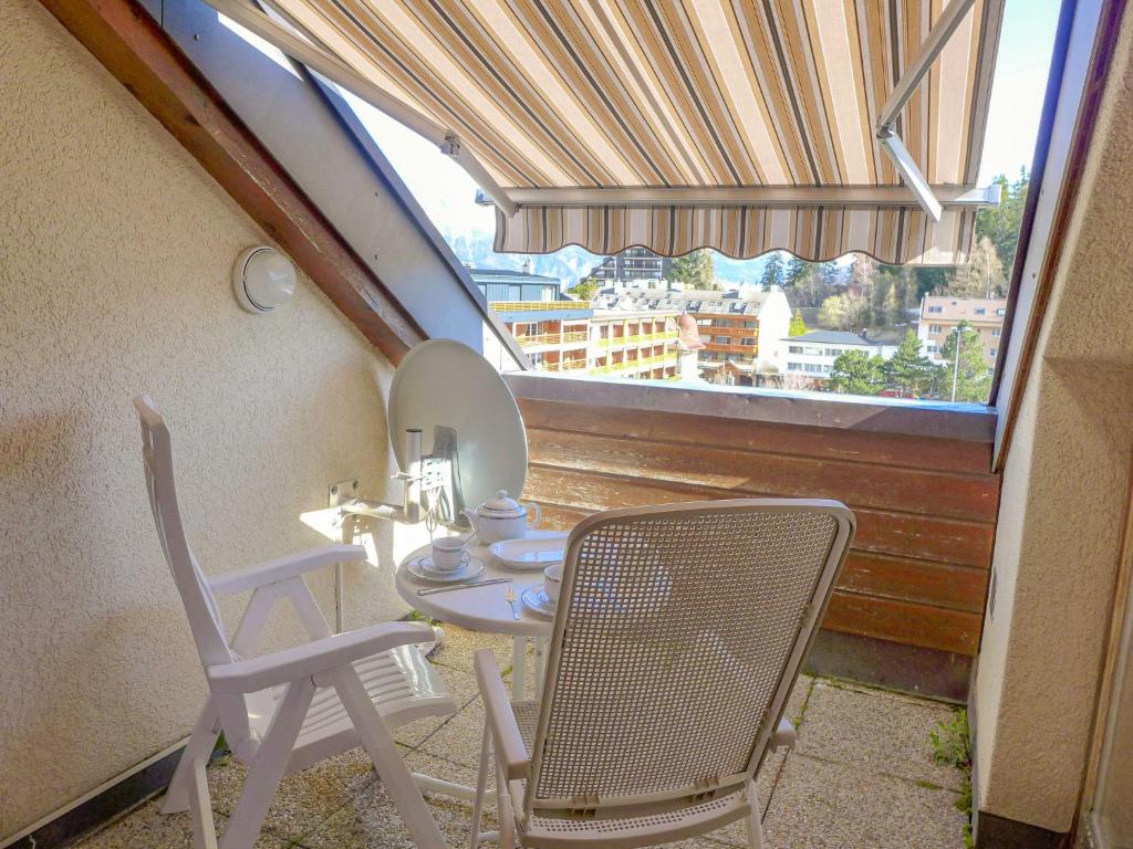 克莱恩 蒙塔纳Apartment les Vignettes by Interhome的阳台配有桌椅和镜子