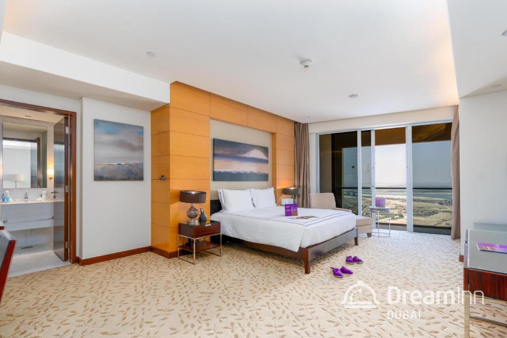 迪拜Dream Inn Apartments - Premium Apartments Connected to Dubai Mall的一间卧室设有一张大床和一个大窗户