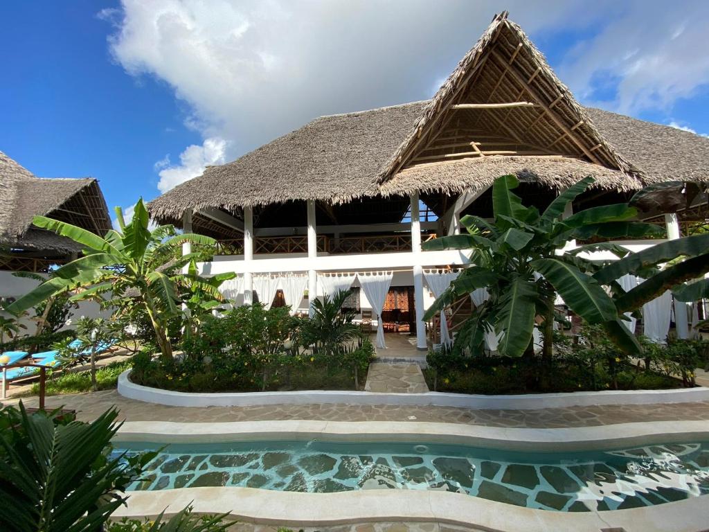 瓦塔穆Paka House-Rafiki Village的一座带游泳池和大楼的度假村