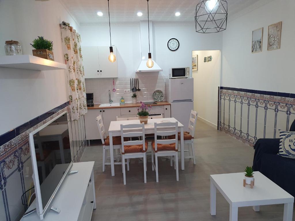 卡莱塔德贝莱斯Brisas del mar的厨房以及带桌椅的起居室。