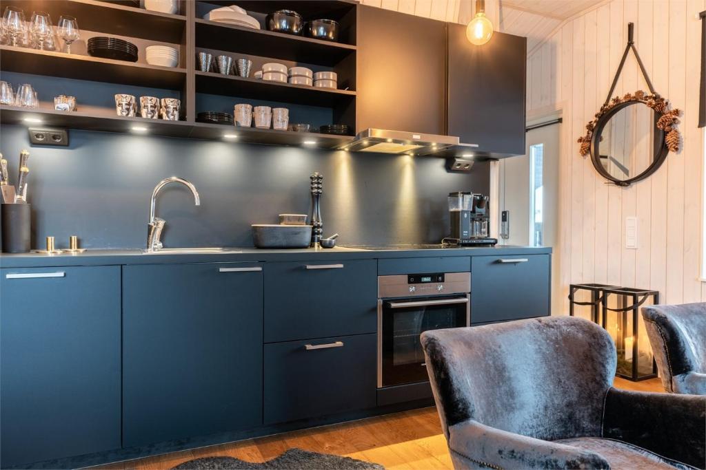 萨伦Fjällnära Skilodge 19的厨房配有蓝色橱柜和水槽
