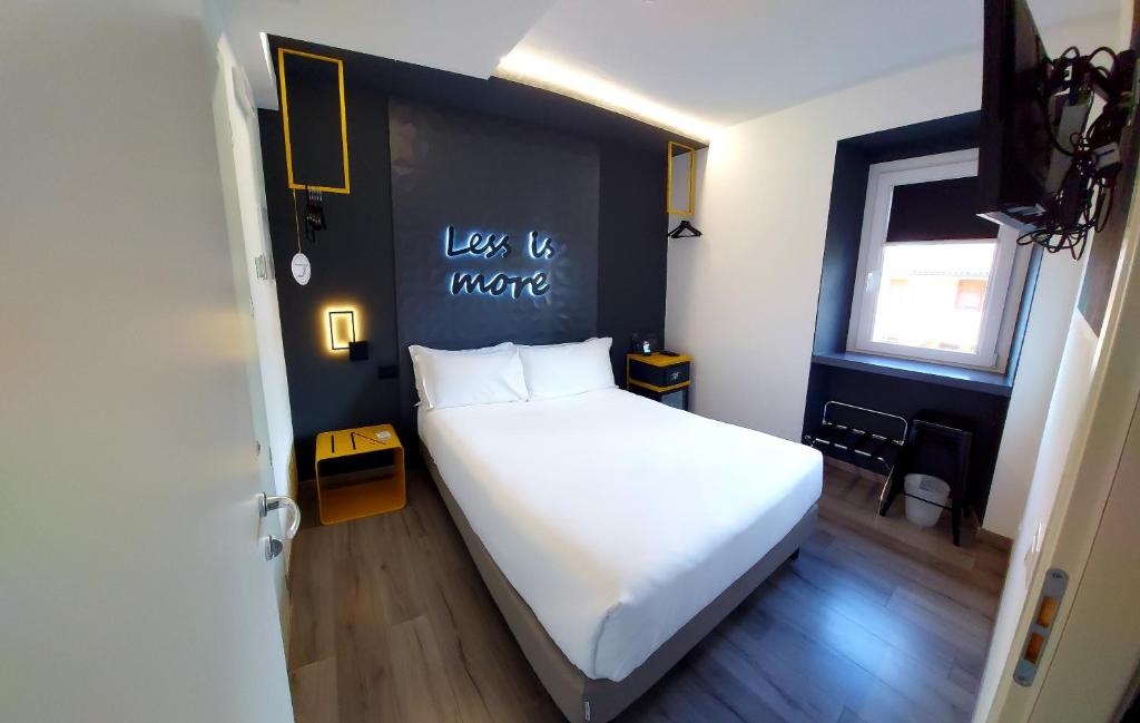 杜伊诺Hotel Aurora Duino的卧室配有白色的床和黑色墙壁