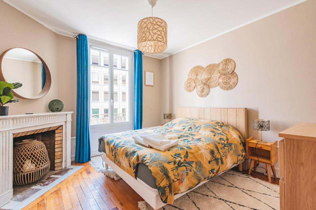兰斯MOULINS - Maison cosy au cœur de Reims的一间卧室配有一张床和一个壁炉
