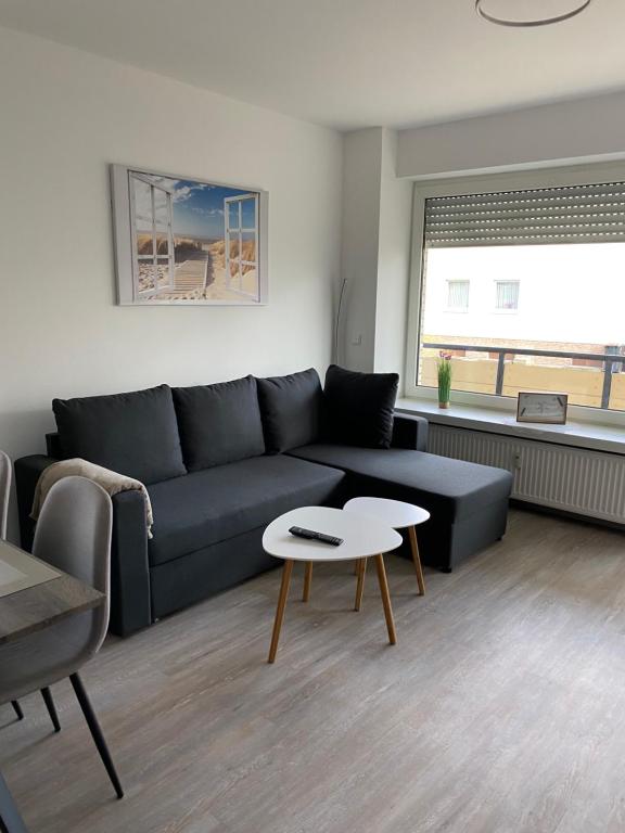 巴特罗森菲尔德Schöne 3 Zimmer Wohnung Mitten in Bad Rothenfelde!的客厅配有蓝色的沙发和桌子