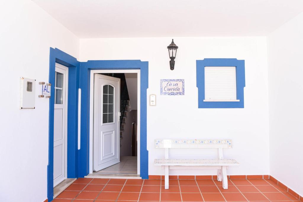 奥比多斯Casa Querida的走廊上设有蓝色和白色的墙壁和长凳