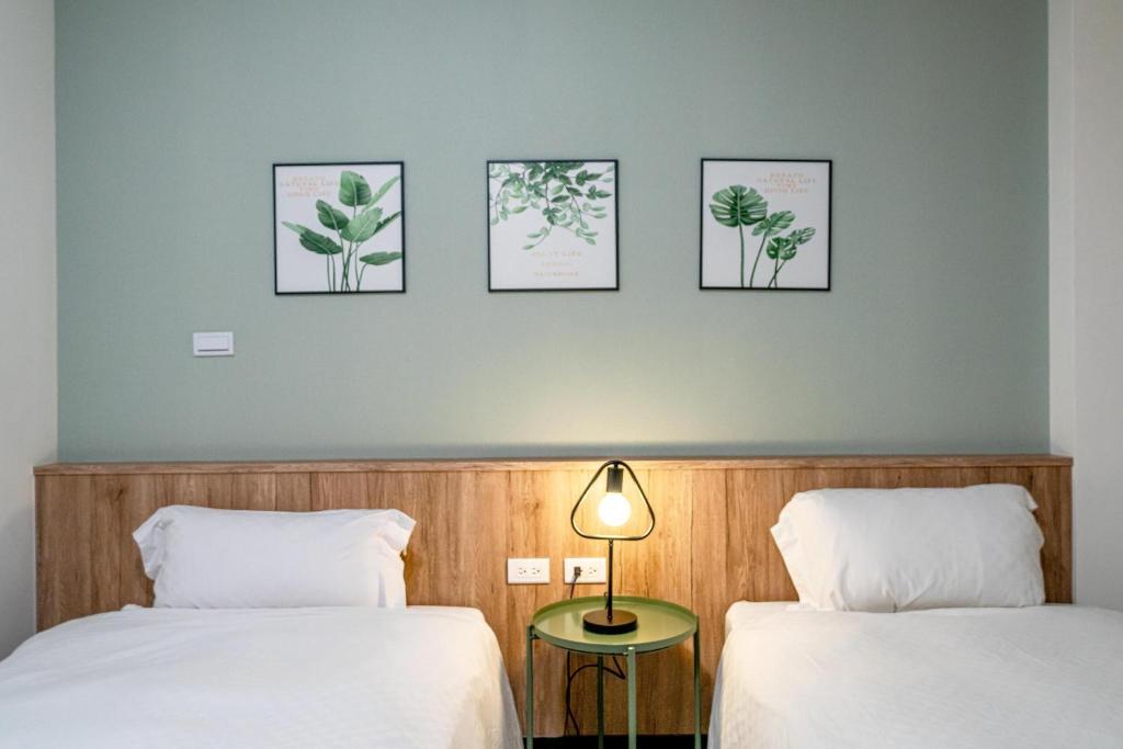 台南公园绿驿的墙上有三张照片的房间的两张床
