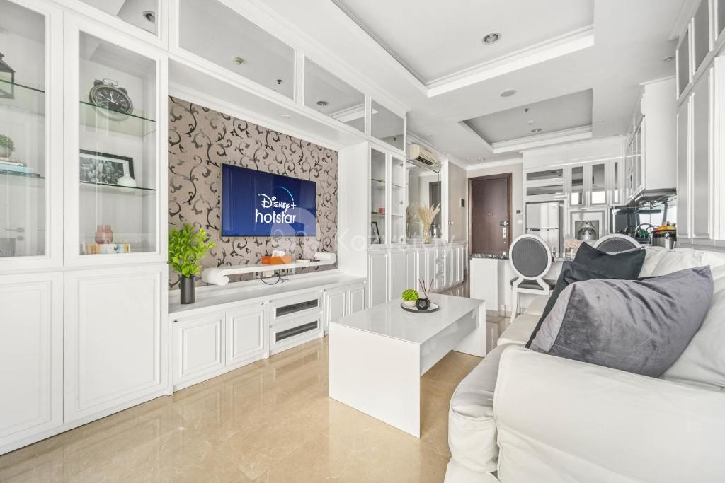 雅加达BLANC by Kozystay - 1BR Apartment in SCBD的客厅配有白色沙发和电视
