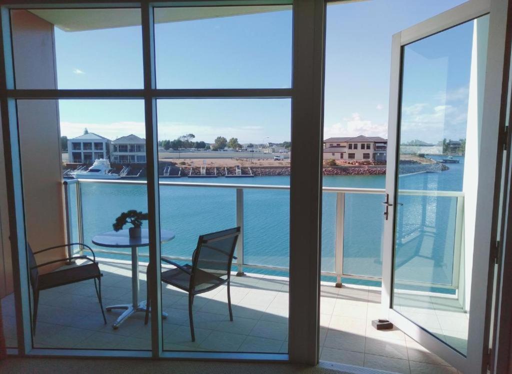 沃拉鲁Apartment 3 Wallaroo Marina的阳台配有桌椅,享有水景。