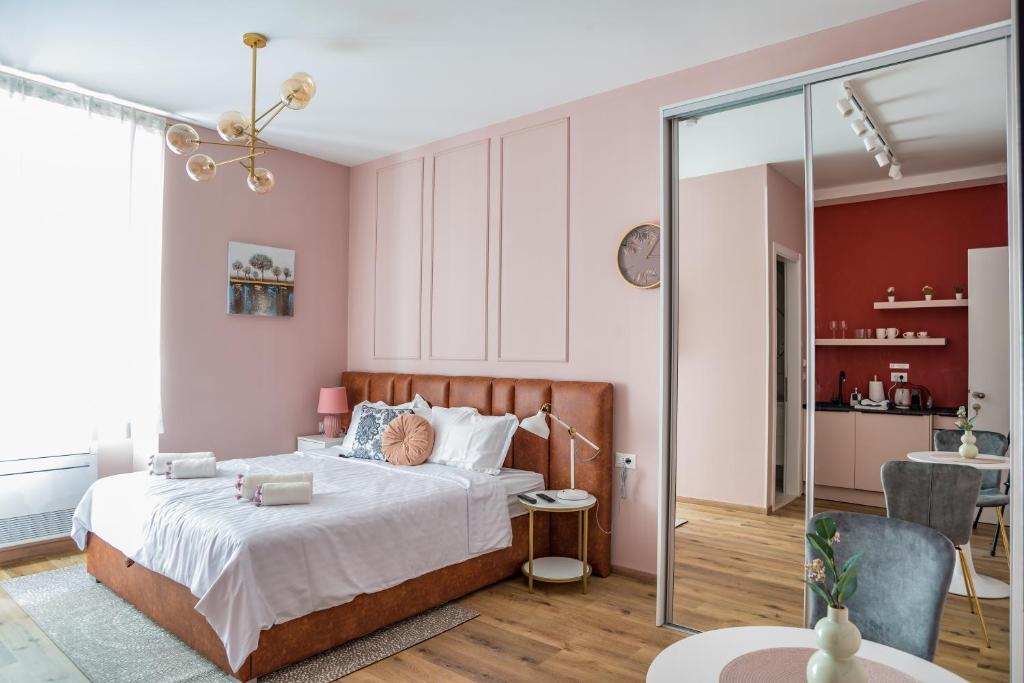 斯普利特Center De Lux Studios “ Zara “的卧室设有粉红色的墙壁和一张带玻璃门的床